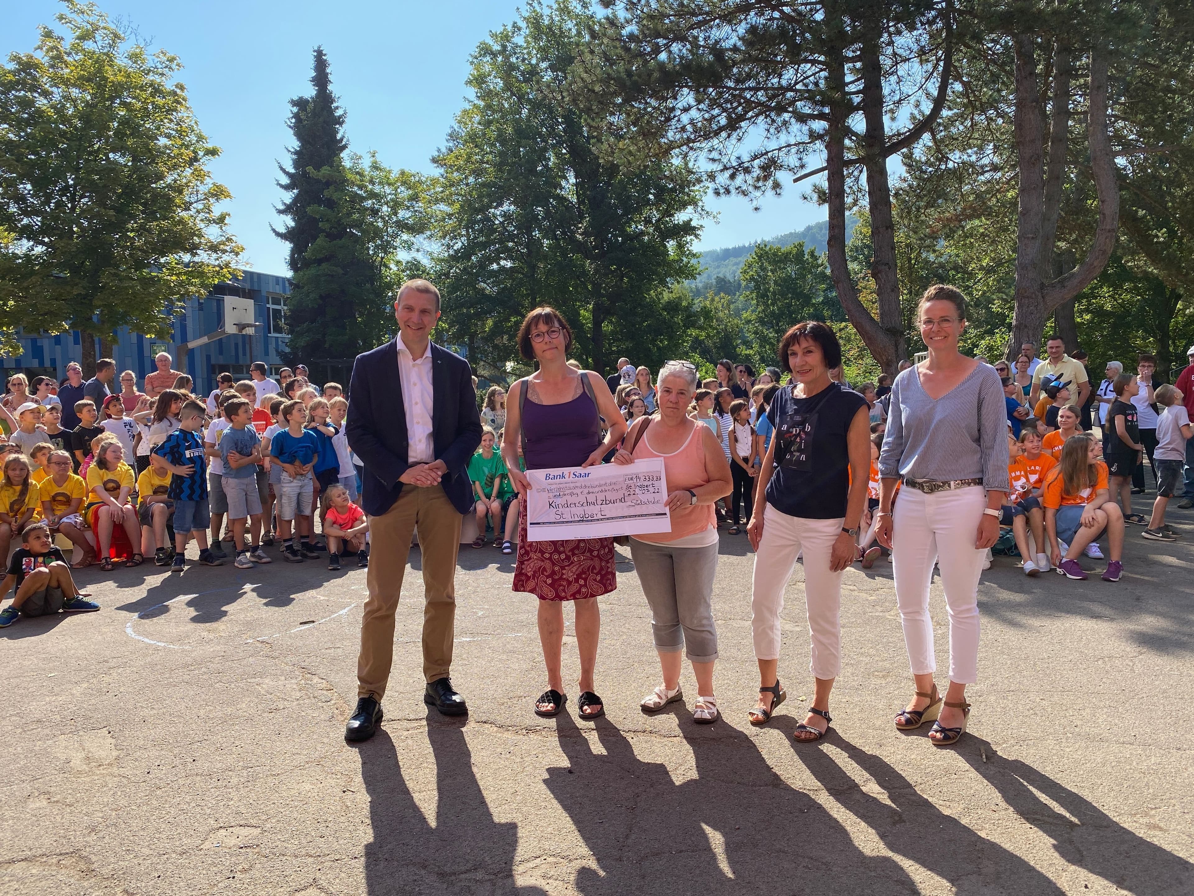 Organisatorin Christine Sassenberger, Oberbürgermeister Ulli Meyer und Ortsvorsteherin Irene Kaiser übergeben einen Spendenscheck an Gerlinde Kaul-Guckel und Petra Gladen vom Kinderschutzbund.