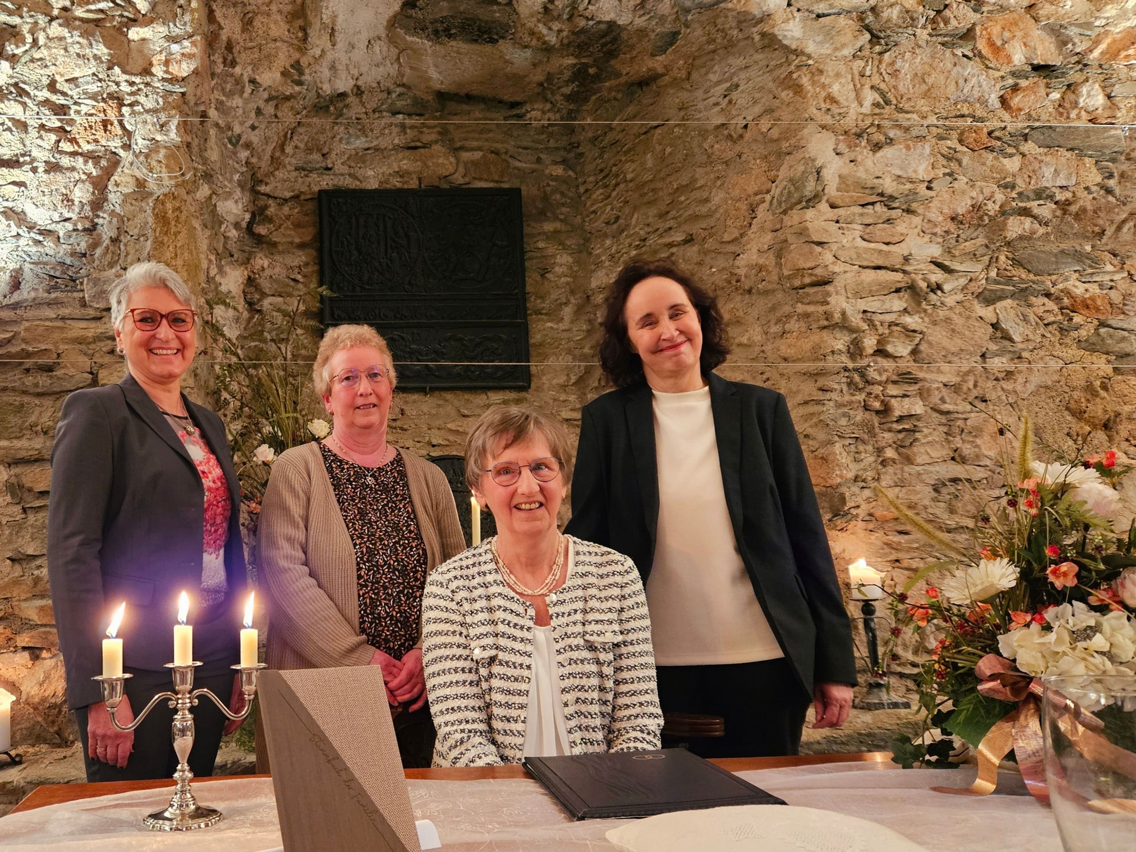 Feierliche Zusammenkunft anlässlich des 20-jährigen Jubiläums der Eheschließungen im historischen Hammerwerk in Braunfels, bei der unter anderem der Bürgermeister und die Standesbeamtinnen anwesend waren.